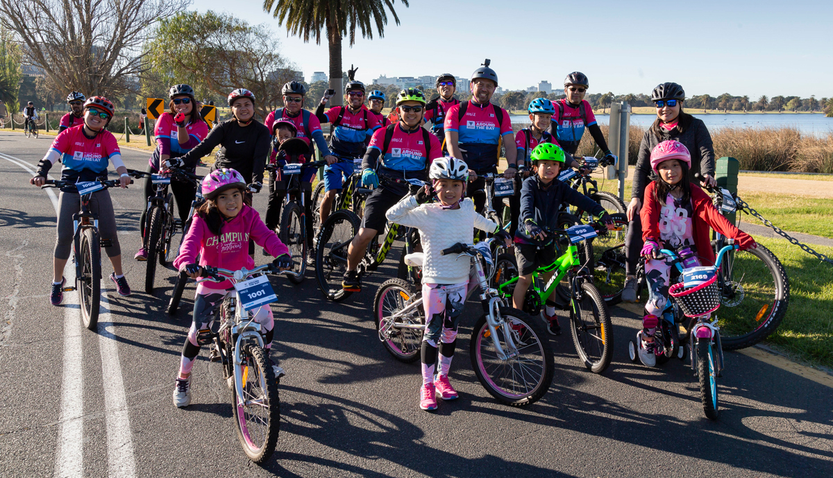 Families posing together at a community cycling event