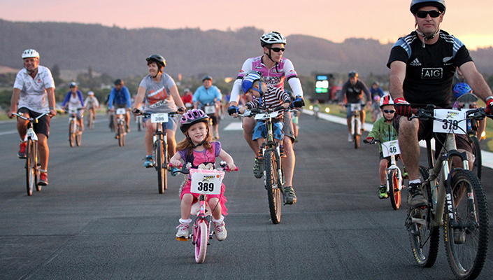 Families cycling together at a community bike race