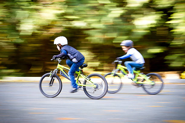 Two young boys racing their bikes