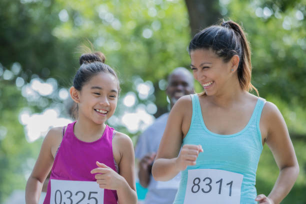Mother and daughter running together in a race